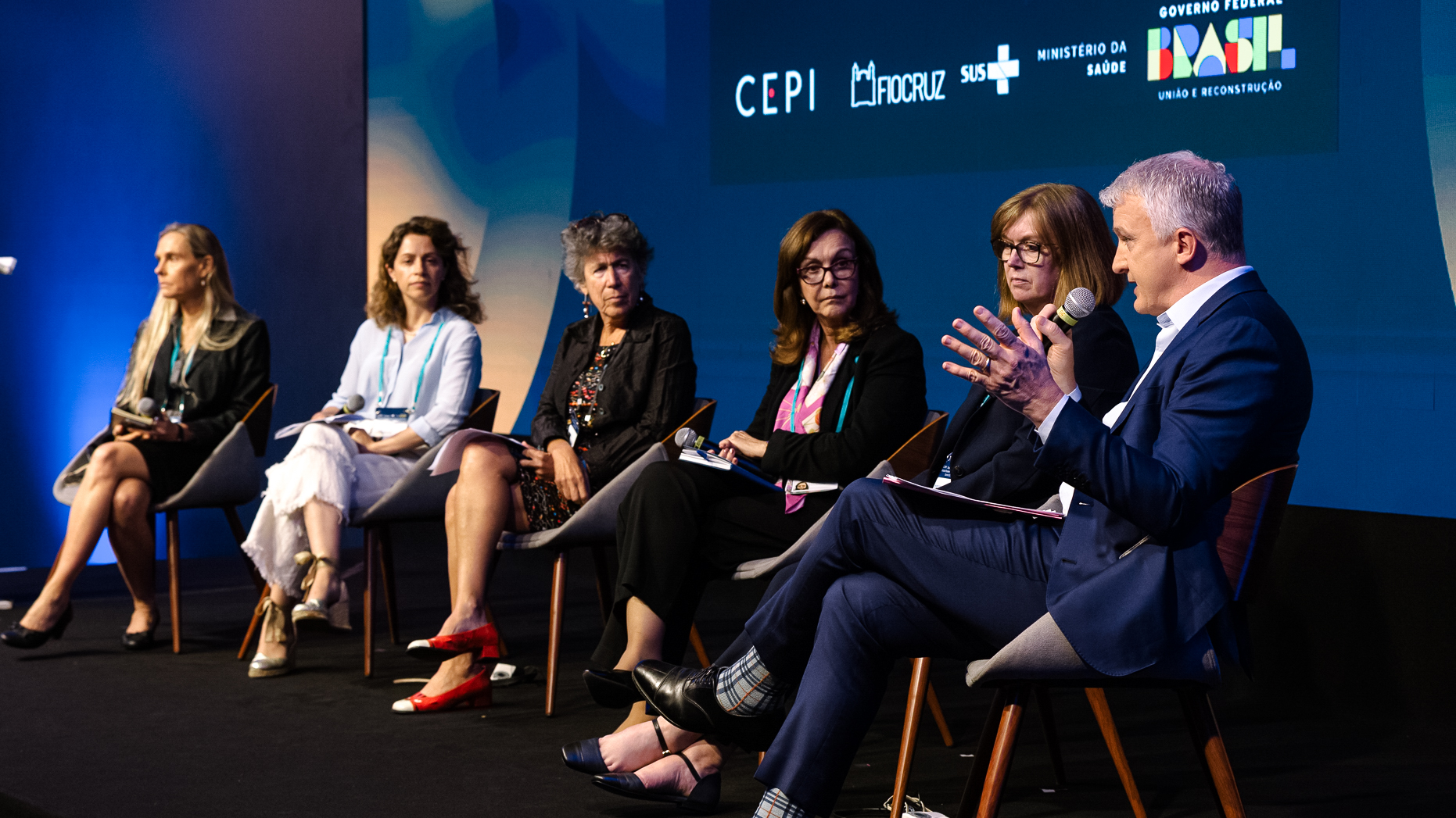 Speakers sat on stage looking towards the speaker talking