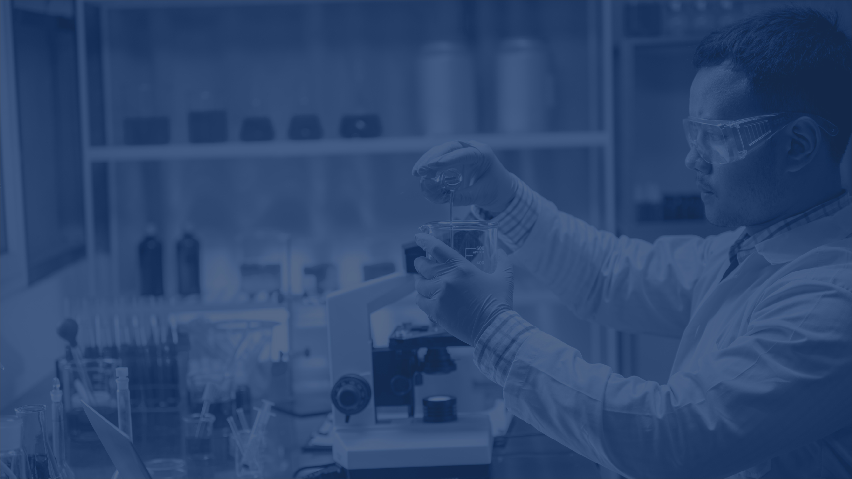 blue filtered photo showing a scientist in a lab