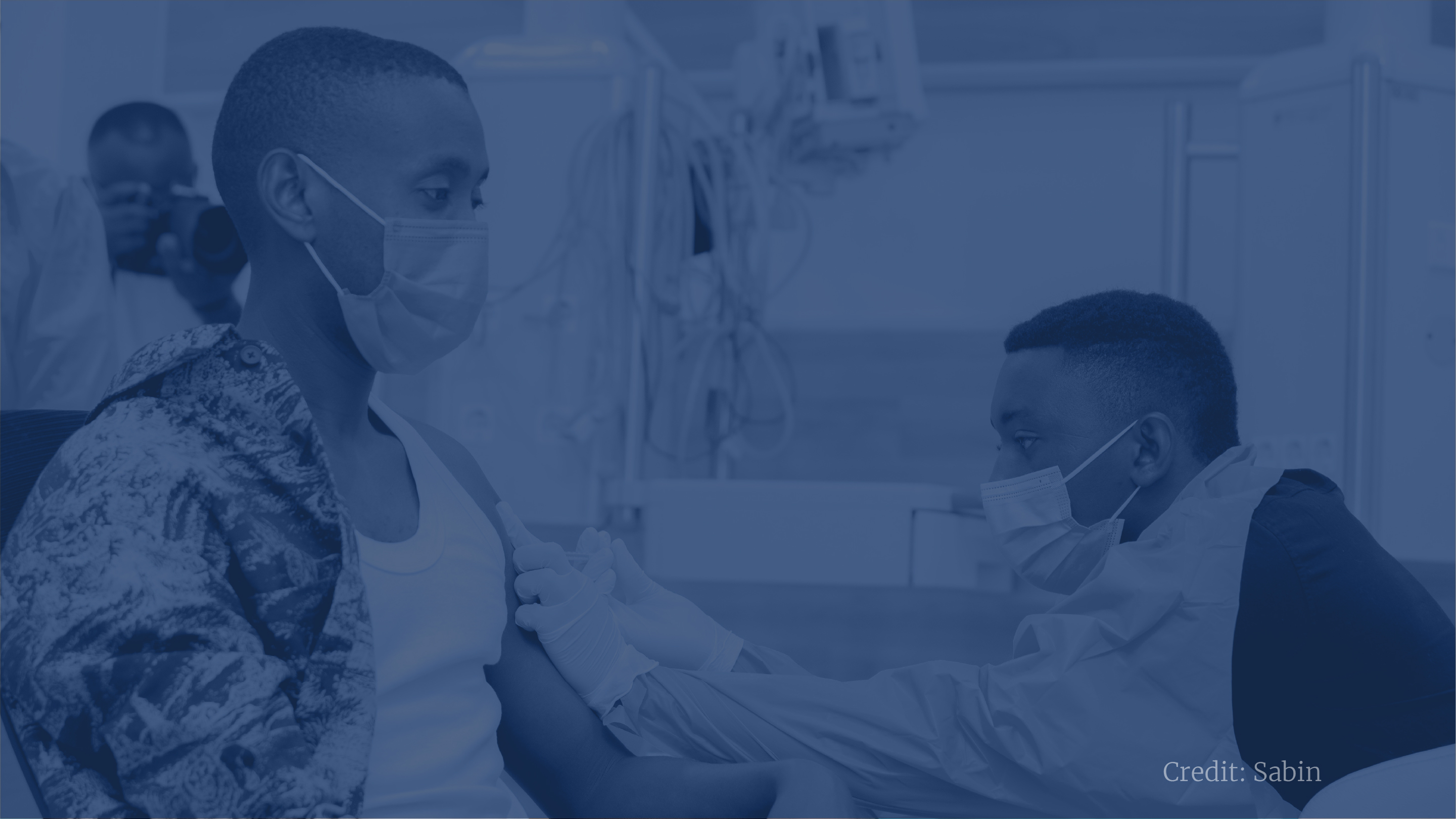 blue filtered photo showing a man getting vaccinated 