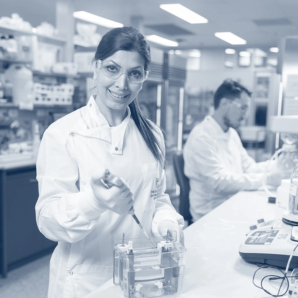 female scientist working in the lab looking at the camera