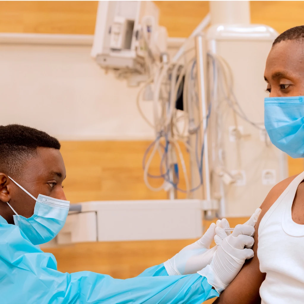 man sat in chair receiving a vaccine