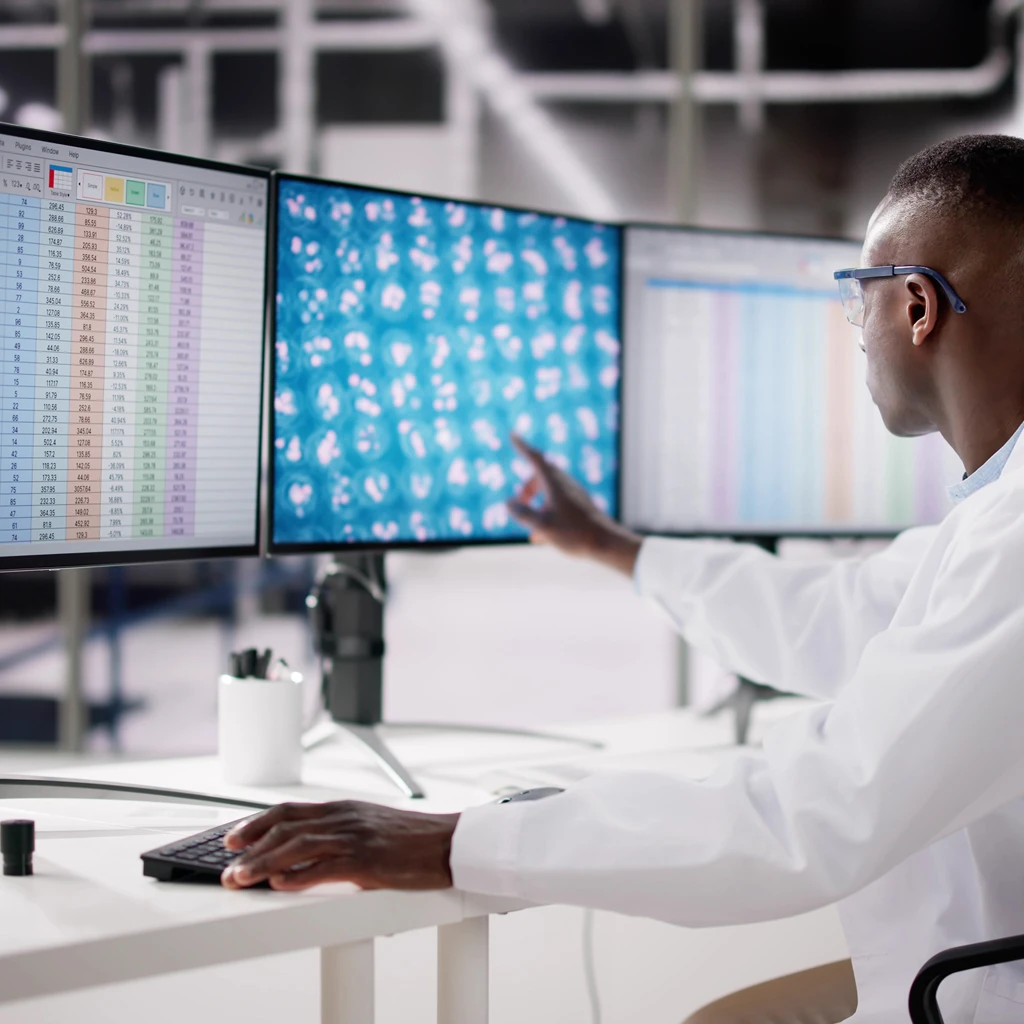 researcher analyzing spreadsheet data in lab setting