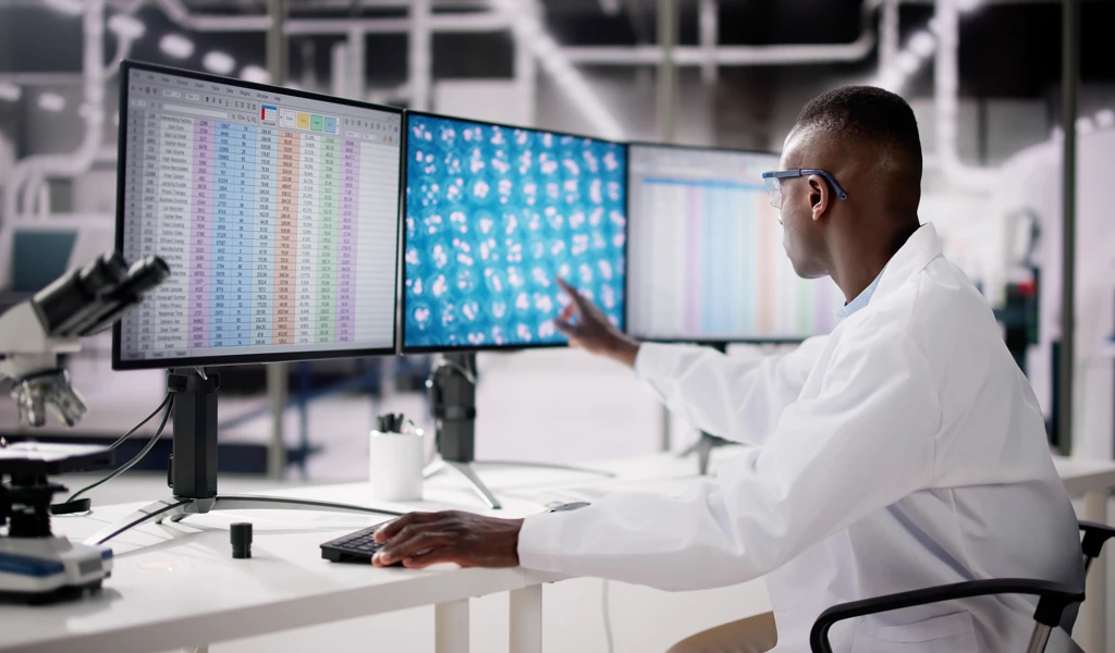 researcher analyzing spreadsheet data in lab setting