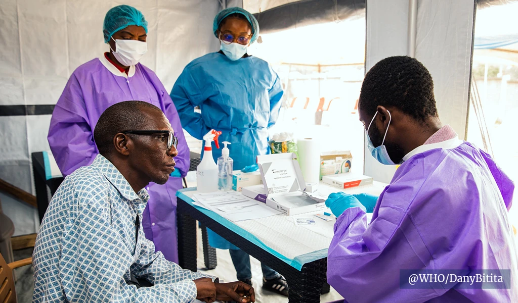 healthcare workers talking to trial participant