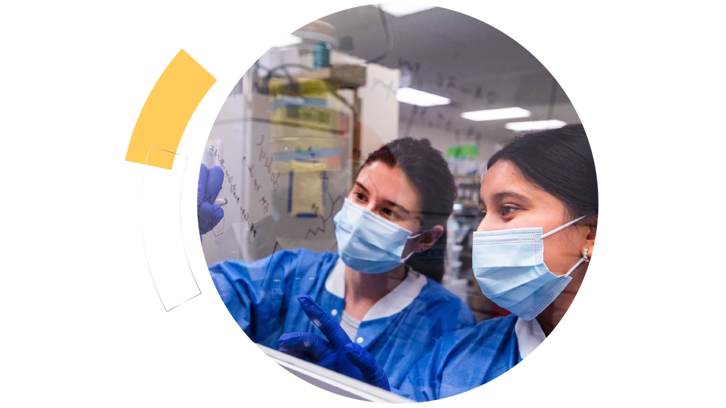 circle frame with photo of two female scientists in