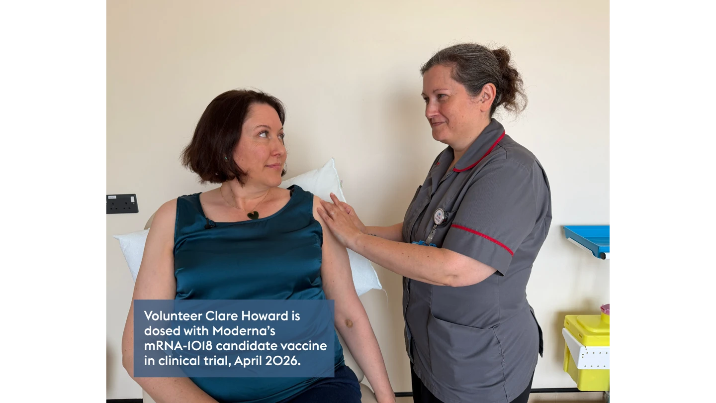 woman sitting in medical room looking at healthcare worker