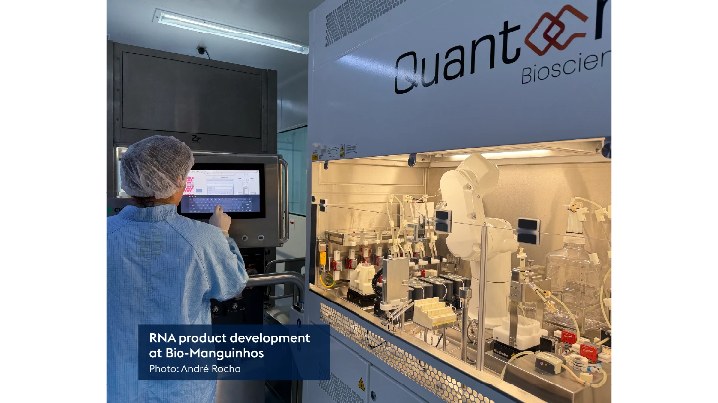 person in lab using a screen surrounded by technical equipment