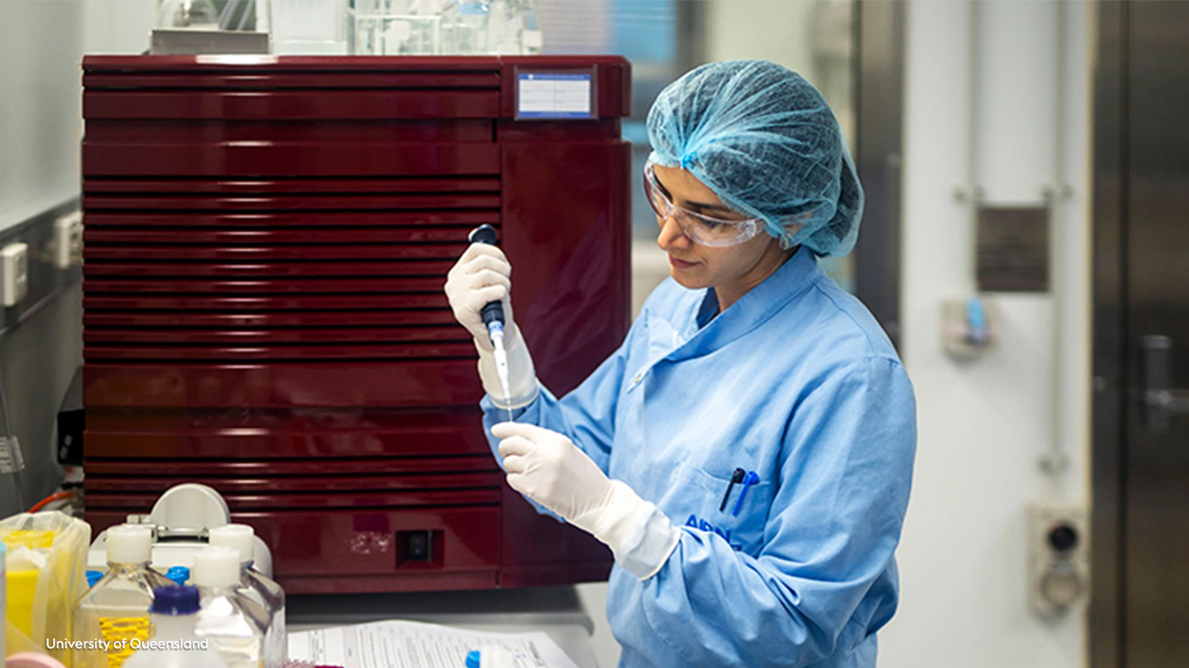 female researcher from the University of Queensland using pipette