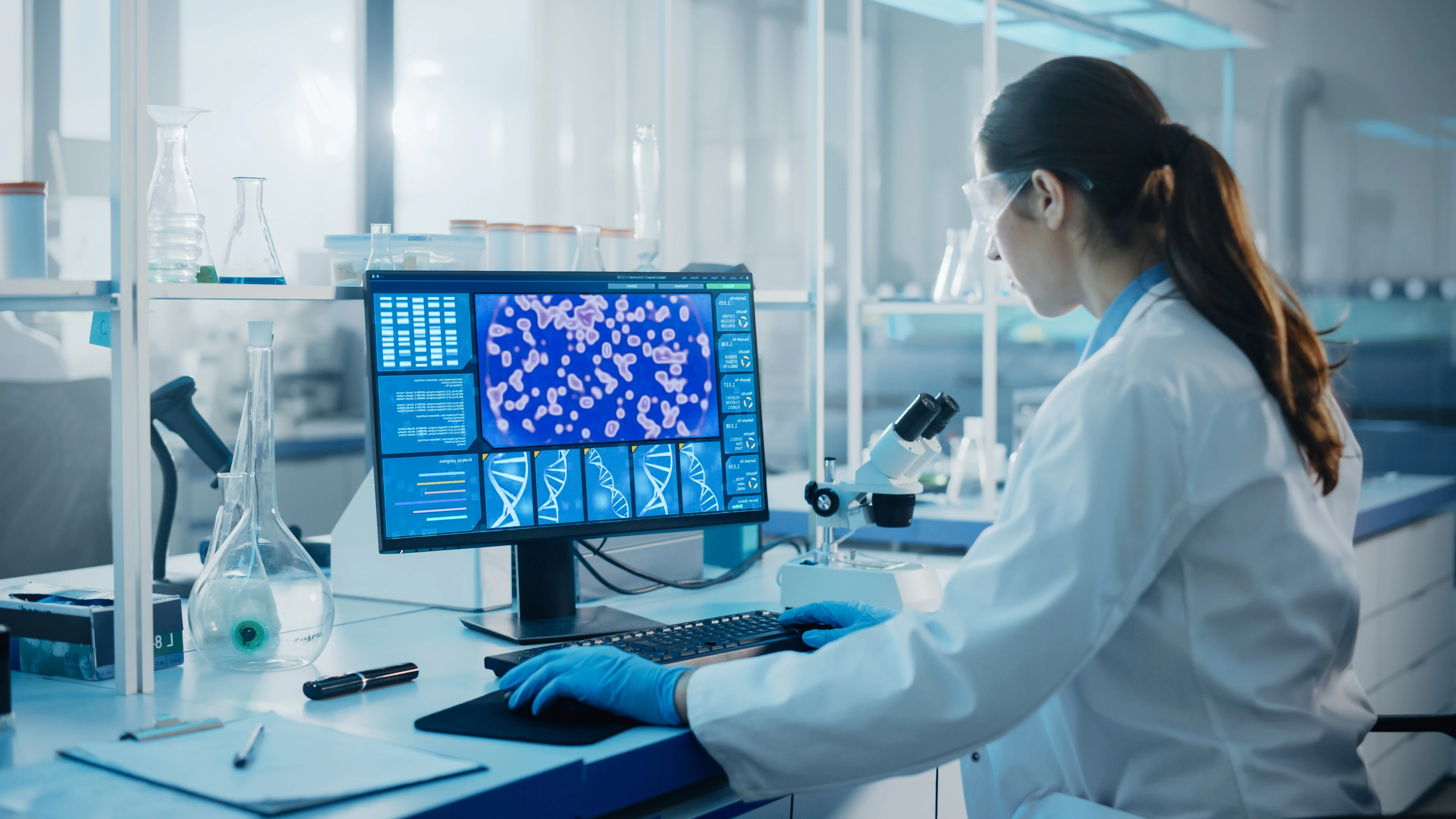 female scientist using a computer in a lab