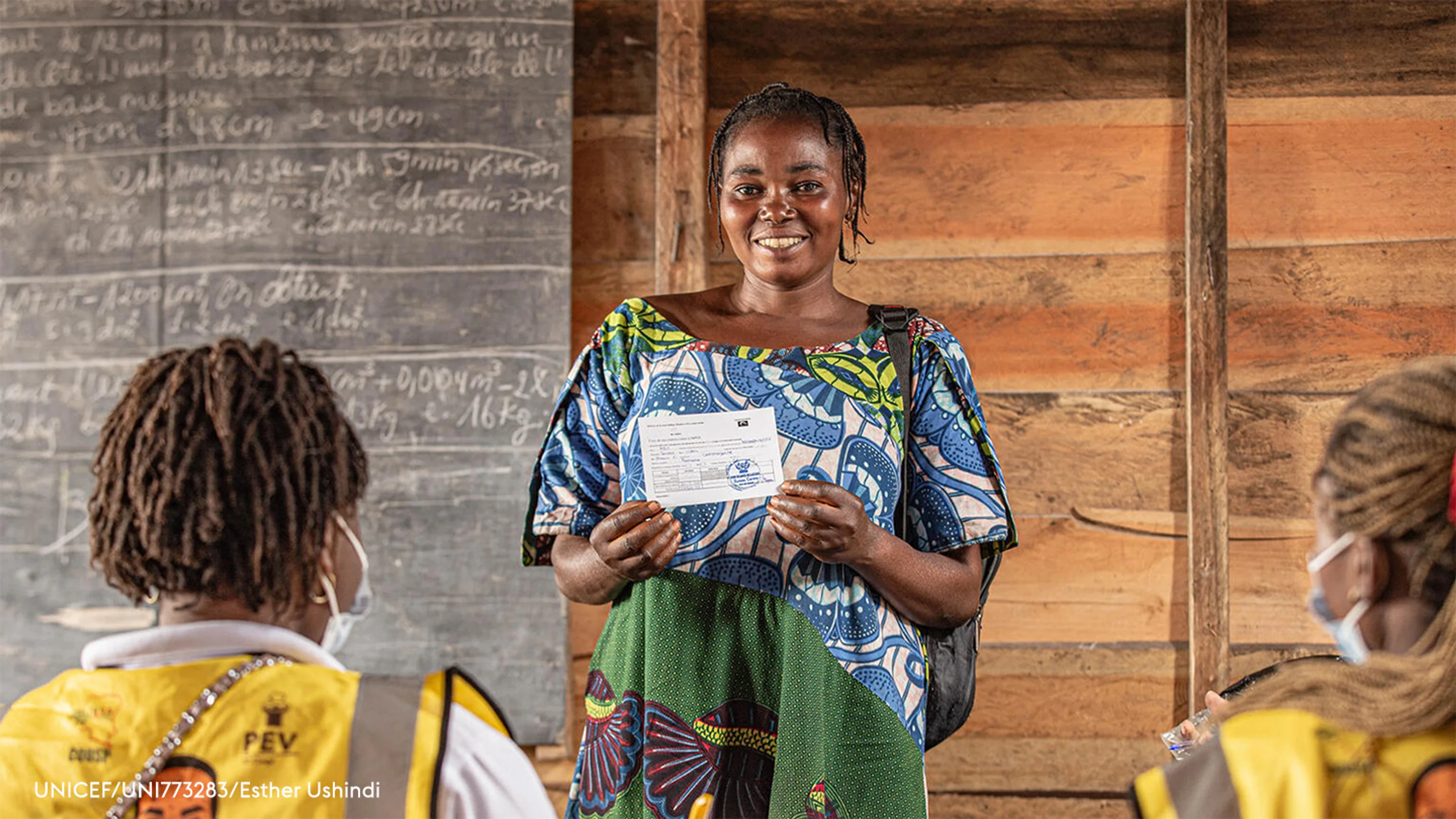 Sauda, a mother of seven, proudly displays her vaccination card after receiving her mpox vaccine at Kabingo Primary School in the Karisimbi health zone, near Goma, in North Kivu province, DR Congo, on 26 March 2025.