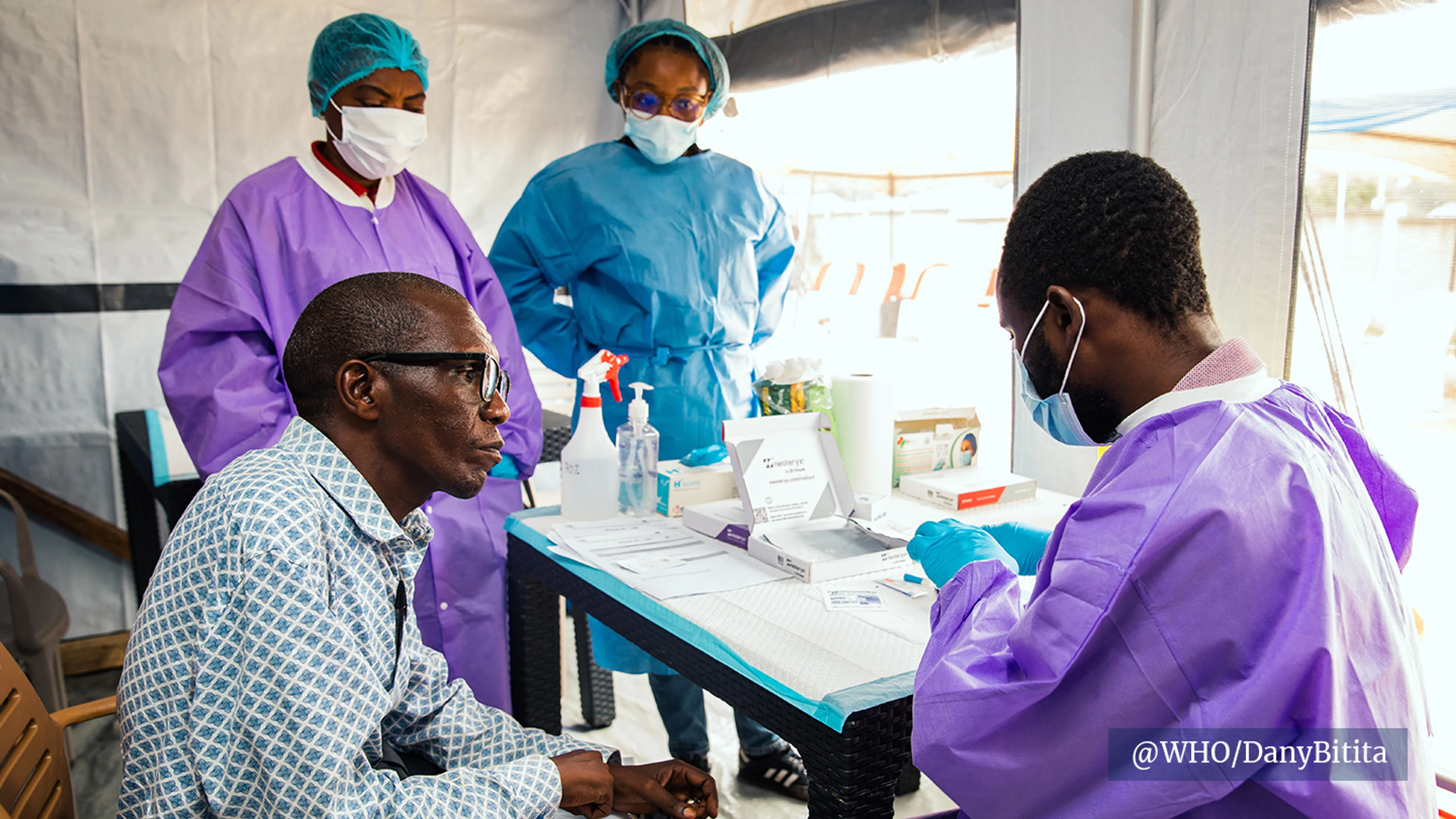 healthcare workers talking to trial participant
